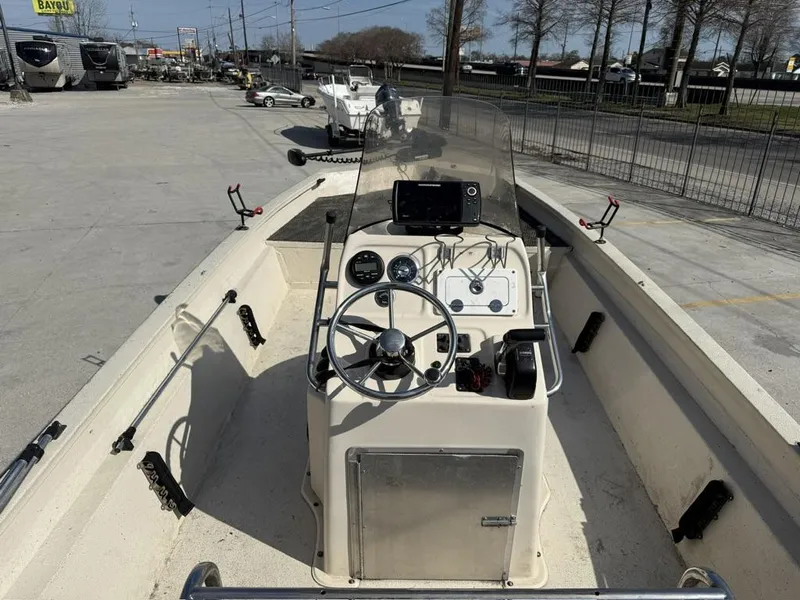 Slide: The Image of 2009 Xpress H20 BAY boat interior with steering wheel and control panel in a parking lot. - 8