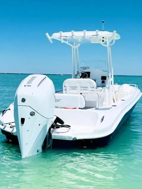 Slide: The Image of 2025 Glasstream 240 CCX boat in clear turquoise water, rear view. - 3