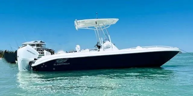 Slide: The Image of 2025 Glasstream 240 CCX boat on clear blue water under a sunny sky. - 4