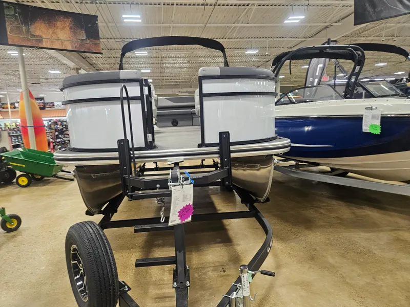 Slide: The Image of 2025 Lowe LS190 pontoon boat on display in a showroom. - 2