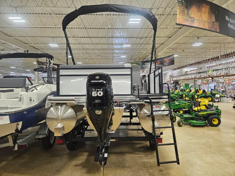 Slide: The Image of 2025 Lowe LS190 boat with Mercury 60 engine displayed in showroom. - 4