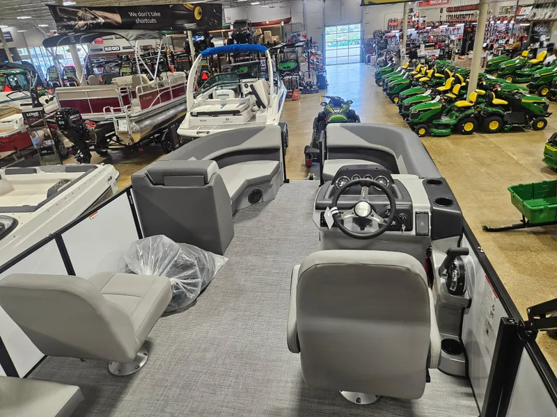 Slide: The Image of 2025 Lowe LS190 boat interior in showroom with steering console and seating. - 5