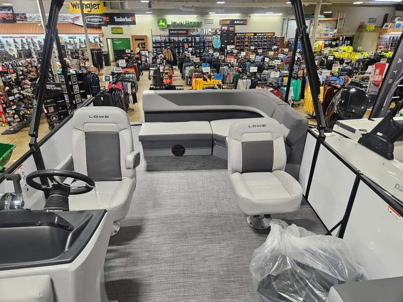 Slide: The Image of 2025 Lowe LS190 boat interior in showroom, featuring gray seating and modern design. - 6