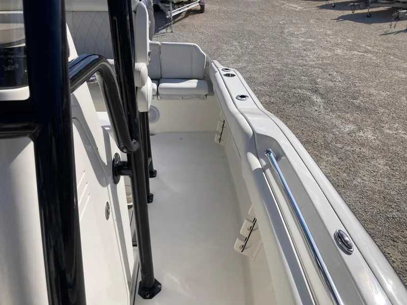 Slide: The Image of 2025 Key West 219fs boat interior with seating and railings. - 14