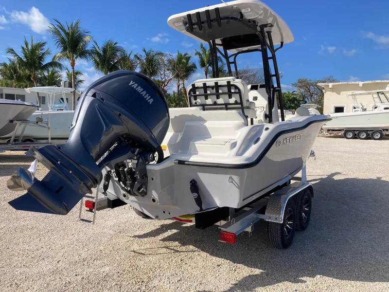 Slide: The Image of 2025 Key West 219fs boat with Yamaha engine on trailer, parked outdoors. - 3
