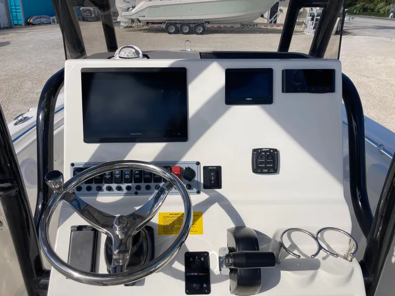 Slide: The Image of 2025 Key West 219fs boat dashboard with steering wheel and electronic displays. - 9