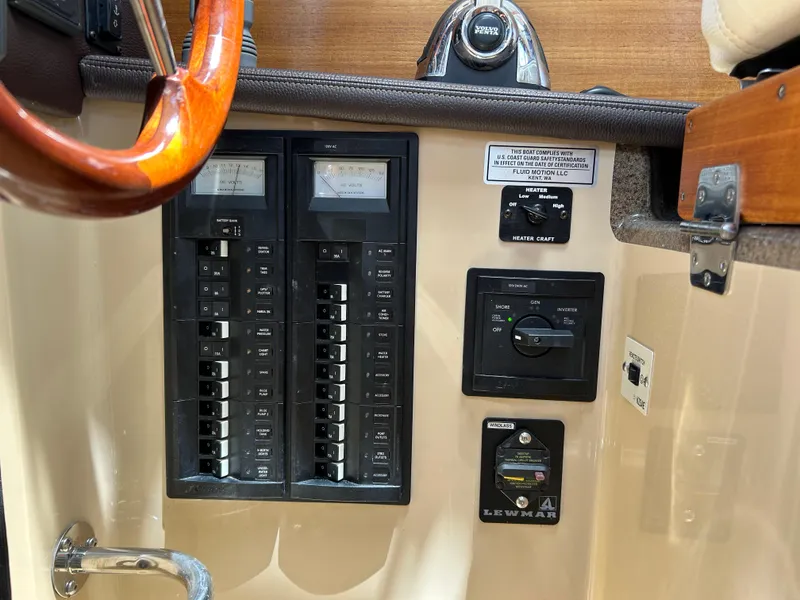 Slide: The Image of Control panel of a 2017 Ranger Tugs R-27 boat with switches and gauges. - 11