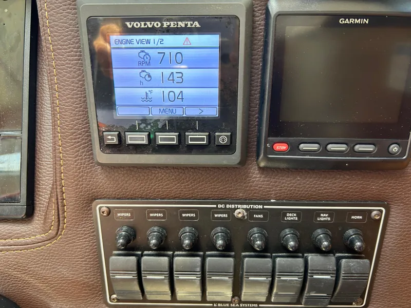 Slide: The Image of Control panel of a 2017 Ranger Tugs R-27 with Volvo Penta and Garmin displays. - 16
