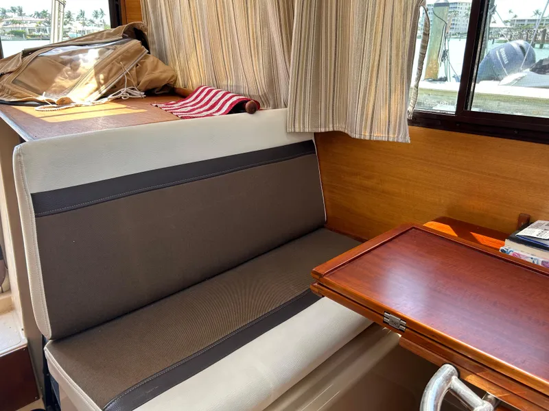 Slide: The Image of Interior of 2017 Ranger Tugs R-27 with seating and wooden table. - 22