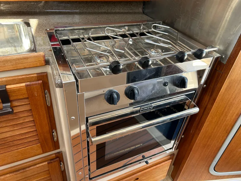 Slide: The Image of Stainless steel stove and oven in 2017 Ranger Tugs R-27 boat kitchen. - 28