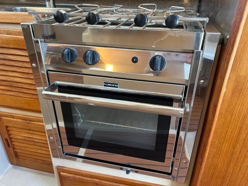 Slide: The Image of Stainless steel oven and stove in 2017 Ranger Tugs R-27 boat kitchen. - 29