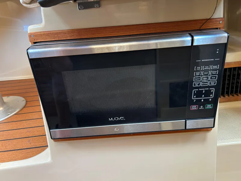 Slide: The Image of Microwave oven inside a 2017 Ranger Tugs R-27 boat, featuring a sleek design and control panel. - 30