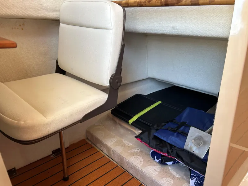 Slide: The Image of 2017 Ranger Tugs R-27 interior with white seat and storage area. - 34