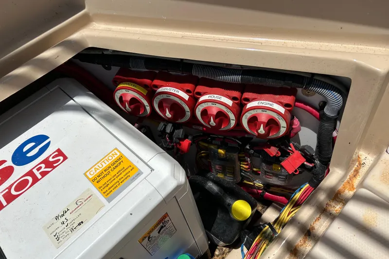 Slide: The Image of 2017 Ranger Tugs R-27 boat battery compartment with switches and wiring. - 37