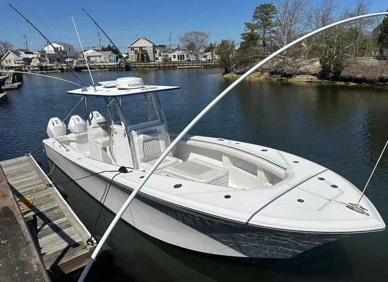 Slide: The Image of 2023 Front Runner 33 Center Console boat docked in a serene marina setting. - 0