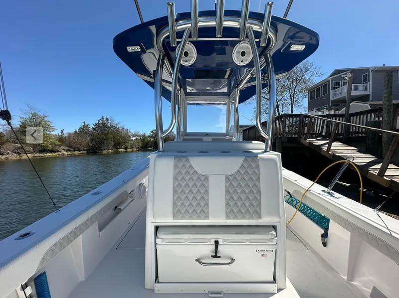 Slide: The Image of 2023 Front Runner 33 Center Console boat docked by a wooden pier. - 10