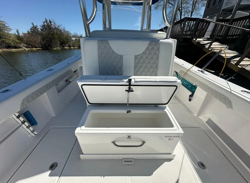 Slide: The Image of 2023 Front Runner 33 Center Console boat with open storage compartment on deck. - 11