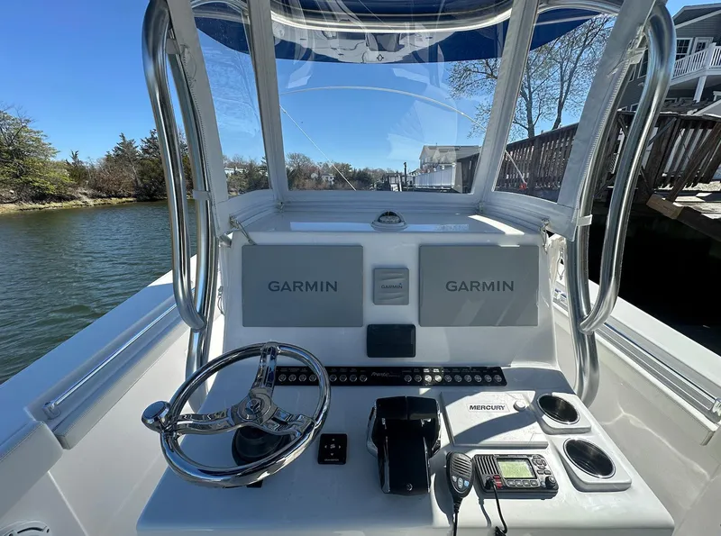 Slide: The Image of 2023 Front Runner 33 Center Console boat dashboard with Garmin navigation system. - 16