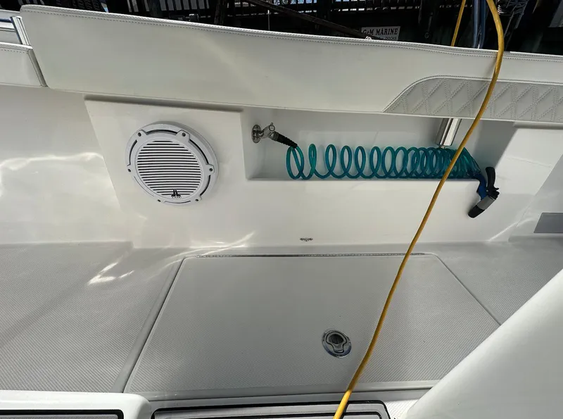 Slide: The Image of 2023 Front Runner 33 Center Console boat deck with speaker and coiled hose. - 18