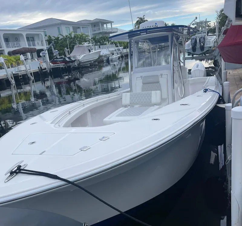 Slide: The Image of 2023 Front Runner 33 Center Console boat docked in a marina. - 2