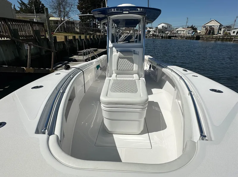 Slide: The Image of 2023 Front Runner 33 Center Console boat docked by waterfront homes. - 20