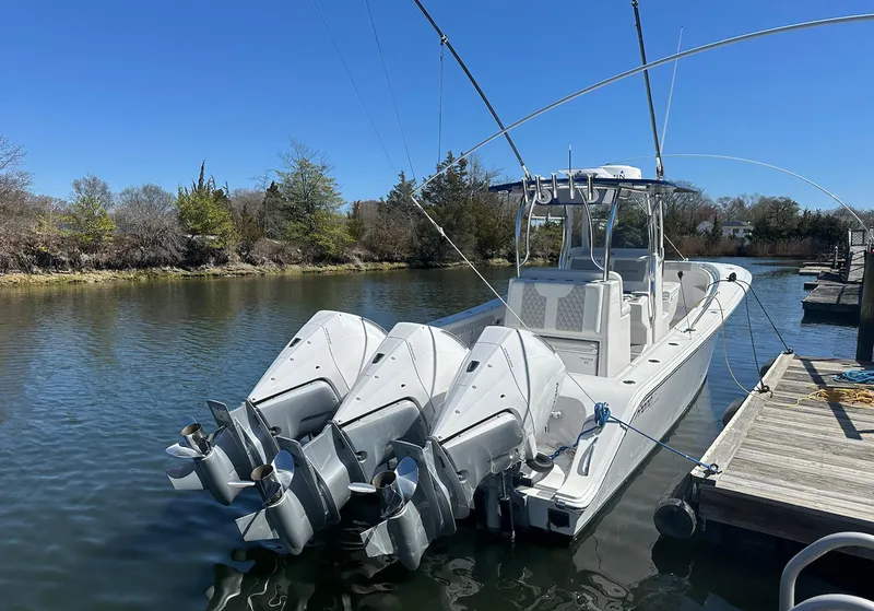 Slide: The Image of 2023 Front Runner 33 Center Console boat docked with triple outboard engines. - 3