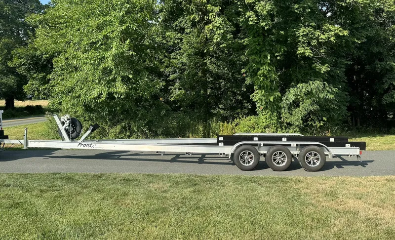 Slide: The Image of Trailer for 2023 Front Runner 33 Center Console, parked on a sunny road. - 30