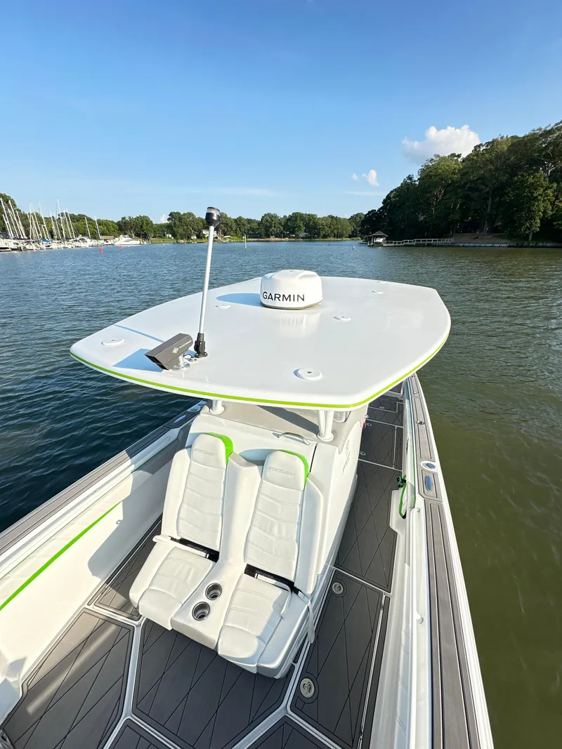 Slide: The Image of 2023 Statement 350 Open boat on calm water, featuring sleek design and advanced navigation equipment. - 12