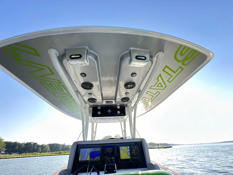 Slide: The Image of 2023 Statement 350 Open boat console with advanced navigation systems and sleek design. - 14