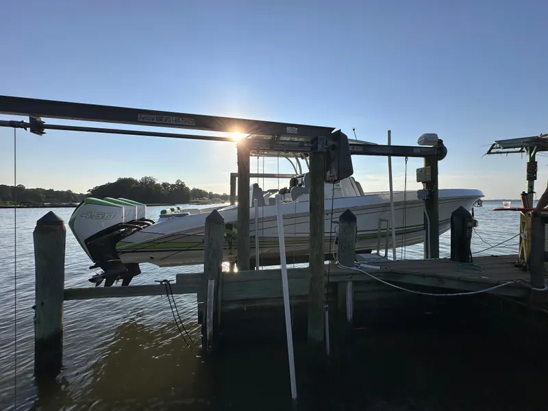 Slide: The Image of 2023 Statement 350 Open boat docked at sunset, with scenic water view. - 28