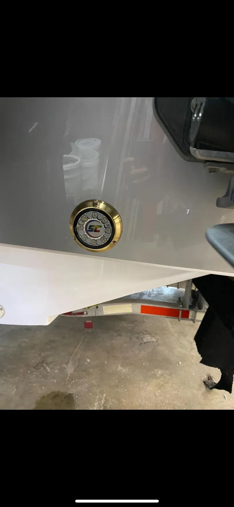 Slide: The Image of 2023 Statement 350 Open boat detail in a garage setting. - 29