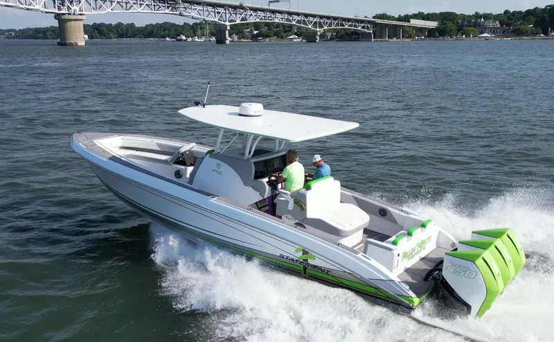 Slide: The Image of 2023 Statement 350 Open boat cruising on water near a bridge. - 5