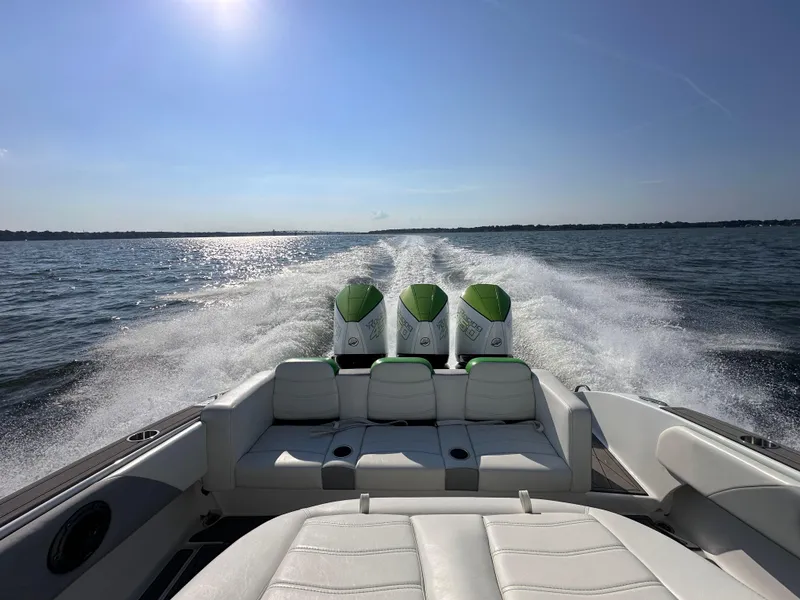 Slide: The Image of 2023 Statement 350 Open boat cruising on open water with triple engines. - 6