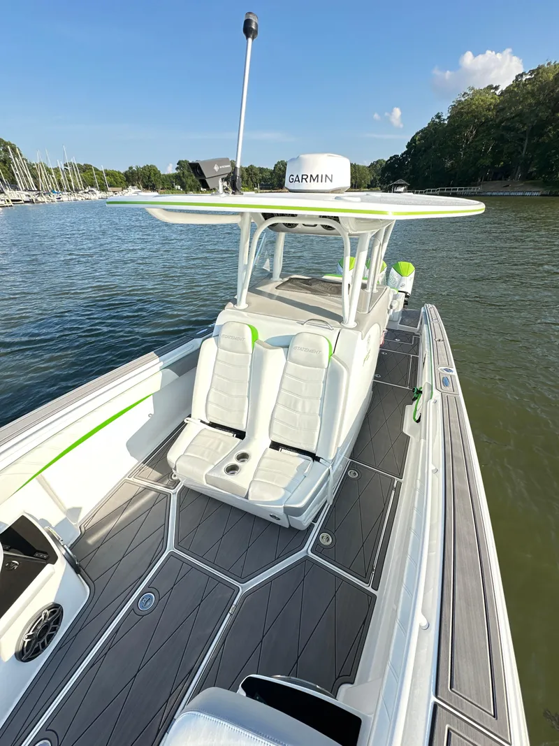 Slide: The Image of 2023 Statement 350 Open boat with sleek design, docked on calm water. - 8