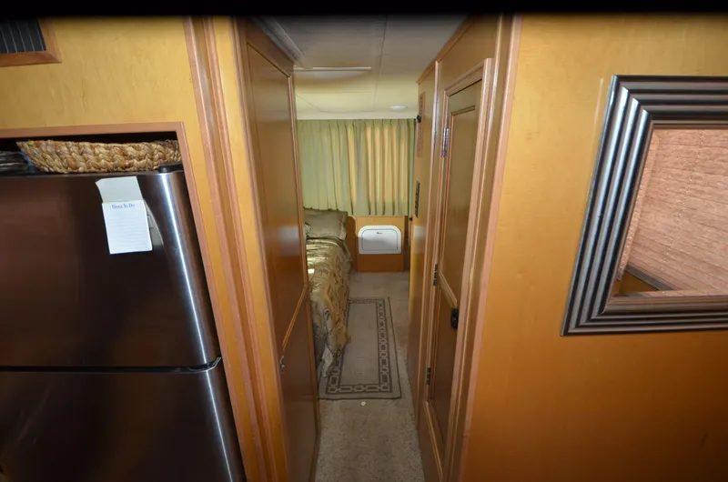 Slide: The Image of Interior of a 2008 Gibson 47 Classic boat with hallway and bedroom view. - 10