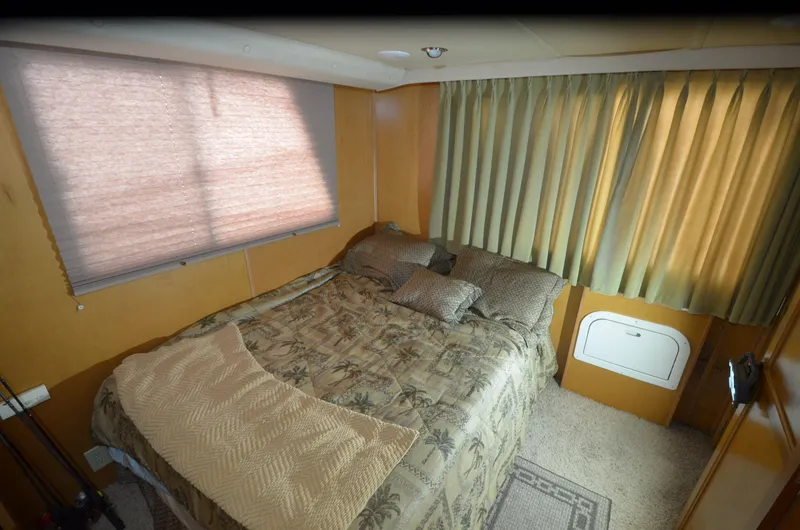 Slide: The Image of Cozy bedroom in 2008 Gibson 47 Classic boat with patterned bedding and curtains. - 11