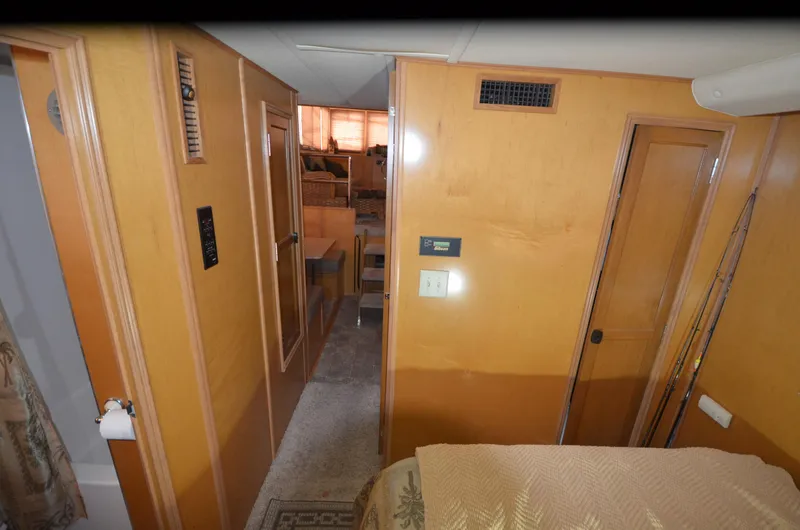 Slide: The Image of Interior of a 2008 Gibson 47 Classic boat with wood paneling and cozy furnishings. - 15