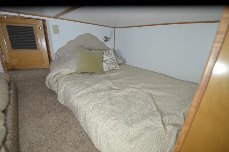 Slide: The Image of Cozy bedroom in 2008 Gibson 47 Classic boat with beige bedding and wooden accents. - 18