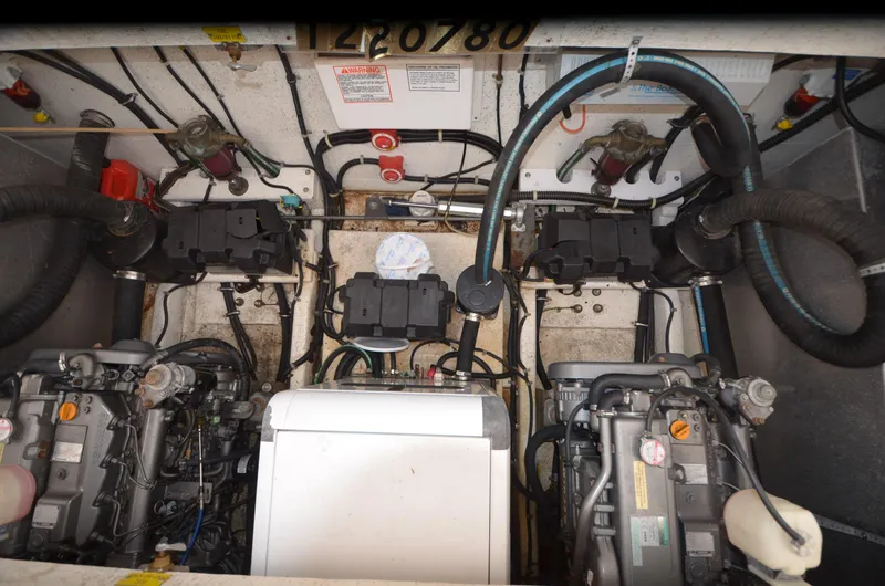 Slide: The Image of Engine room of a 2008 Gibson 47 Classic boat, featuring dual engines and mechanical components. - 19