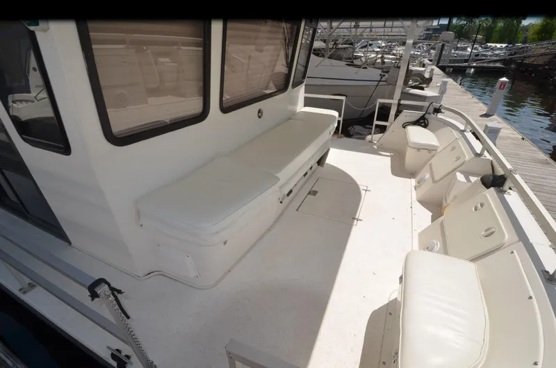 Slide: The Image of 2008 Gibson 47 Classic boat deck with seating and dock view. - 25