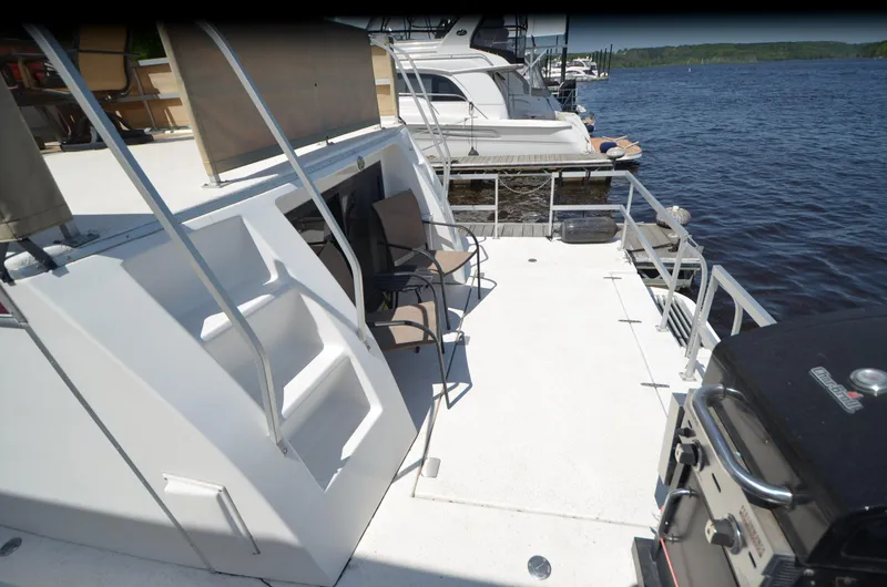 Slide: The Image of 2008 Gibson 47 Classic yacht deck with seating, grill, and waterfront view. - 28
