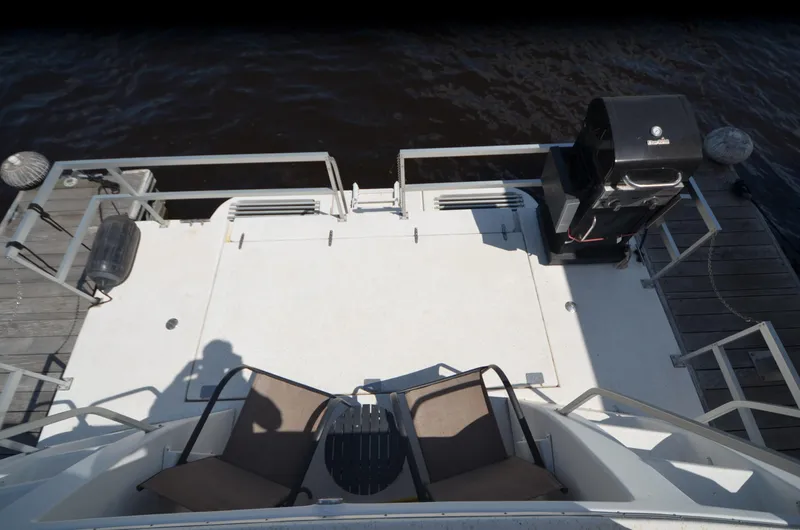 Slide: The Image of Rear deck of 2008 Gibson 47 Classic boat with chairs and grill. - 29