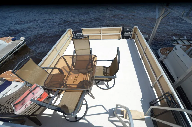Slide: The Image of 2008 Gibson 47 Classic boat deck with patio furniture overlooking the water. - 34