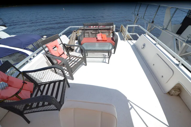Slide: The Image of Upper deck of 2008 Gibson 47 Classic boat with seating and table, overlooking water. - 35