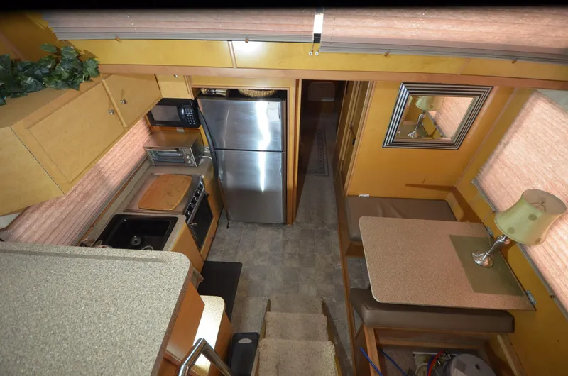Slide: The Image of Interior of a 2008 Gibson 47 Classic boat with kitchen and dining area. - 6
