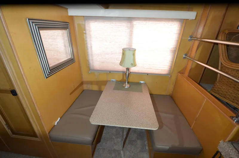 Slide: The Image of 2008 Gibson 47 Classic interior with dining nook, table, lamp, and window. - 7