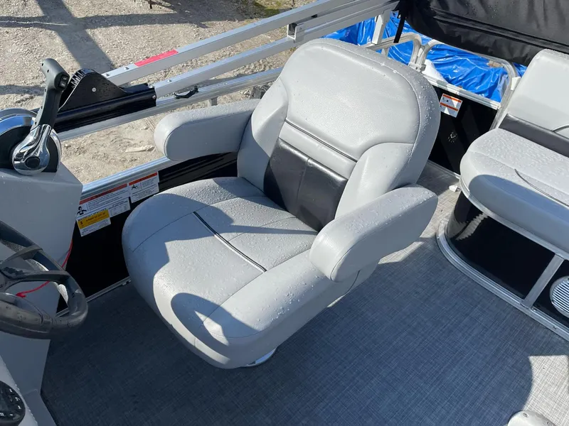 Slide: The Image of Captain's chair on 2020 Lowe Ultra 160 Cruise pontoon boat, featuring gray upholstery. - 10