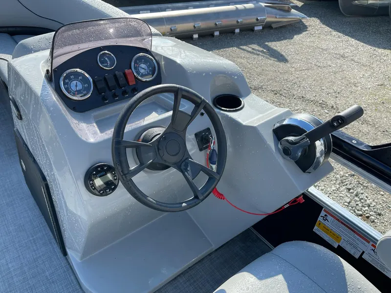 Slide: The Image of 2020 Lowe Ultra 160 Cruise boat dashboard with steering wheel and control panel. - 11
