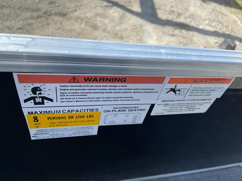 Slide: The Image of Warning label on 2020 Lowe Ultra 160 Cruise boat, indicating maximum capacity and safety instructions. - 14