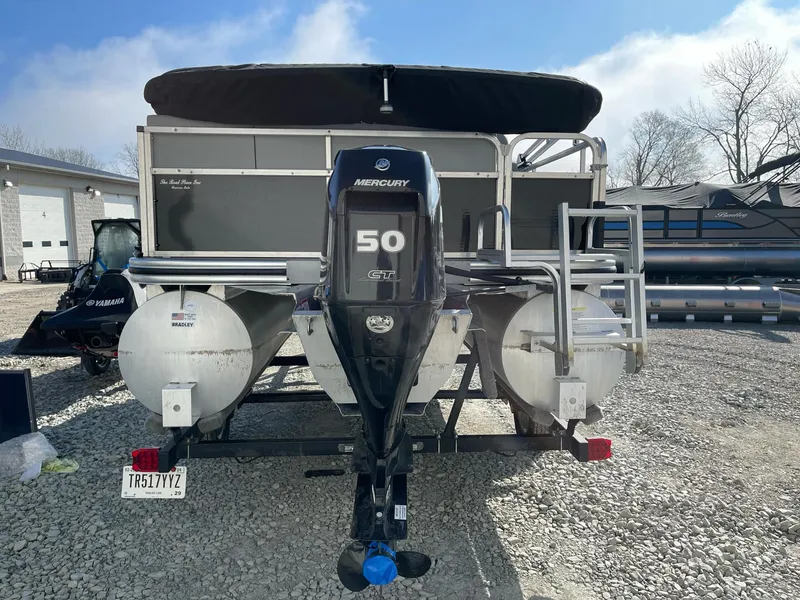 Slide: The Image of 2020 Lowe Ultra 160 Cruise pontoon boat with Mercury 50 HP engine, parked on gravel. - 4